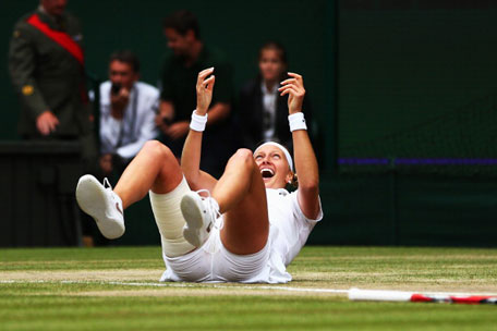 Petra Kvitova of Czech Republic falls to the floor as she celebrates championship point and winning the Ladies' Singles final match against Eugenie Bouchard of Canada on day twelve of the Wimbledon Lawn Tennis Championships at the All England Lawn Tennis and Croquet Club on July 5, 2014 in London, England. (GETTY)