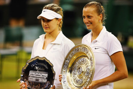 Petra Kvitova (right) of Czech Republic poses with the Venus Rosewater Dish trophy next to Eugenie Bouchard of Canada and her runner-up trophy after their Ladies' Singles final match on day twelve of the Wimbledon Lawn Tennis Championships at the All England Lawn Tennis and Croquet Club on July 5, 2014 in London, England. (GETTY)