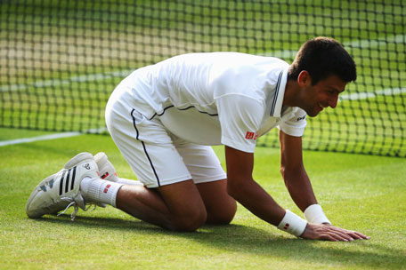 Novak Djokovic of Serbia falls to the turf as he celebrates winning the Gentlemen's Singles Final match against Roger Federer of Switzerland on day thirteen of the Wimbledon Lawn Tennis Championships at the All England Lawn Tennis and Croquet Club on July 6, 2014 in London, England. (GETTY)