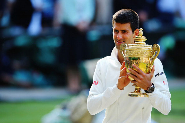 Novak Djokovic of Serbia poses with the Gentlemen's Singles Trophy following his victory in the Gentlemen's Singles Final match against Roger Federer of Switzerland on day thirteen of the Wimbledon Lawn Tennis Championships at the All England Lawn Tennis and Croquet Club on July 6, 2014 in London, England. (GETTY)