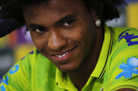 Brazil's Willian smiles as he listens to a question during a press conference at the Granja Comary training center in Teresopolis, Brazil, Sunday, July 6, 2014.  (AP)