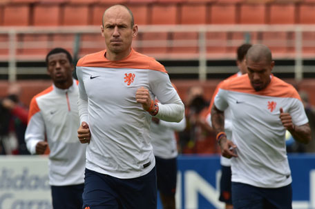 Netherlands' forward Arjen Robben (centre) warms up during a training session at the Paulo Machado de Carvalho Stadium, in Sao Paulo on July 08, on the eve of the 2014 FIFA World Cup semi-final against Argentina. (AFP)
