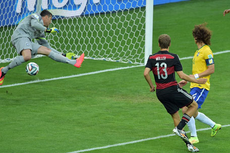 GOAL NO.1: Germany's forward Thomas Mueller (centre) scores their first goal during the semi-final football match between Brazil and Germany at The Mineirao Stadium in Belo Horizonte during the 2014 FIFA World Cup on July 8, 2014. (AFP)
