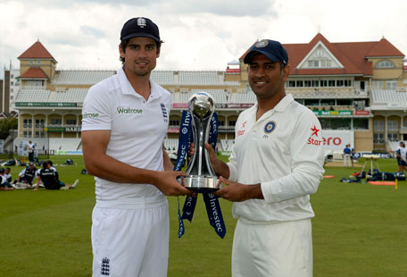 England's captain Alastair Cook (left) stands with India's captain Mahendra Singh Dhoni holding the series trophy before Wednesday's first Test cricket match at Trent Bridge cricket ground in Nottingham, July 8, 2014.  (REUTERS)