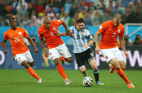 Lionel Messi of Argentina controls the ball as (from left) Georginio Wijnaldum, Nigel de Jong and Ron Vlaar give chase during the 2014 FIFA World Cup Brazil Semi Final match between the Netherlands and Argentina at Arena de Sao Paulo on July 9, 2014 in Sao Paulo, Brazil.  (GETTY)