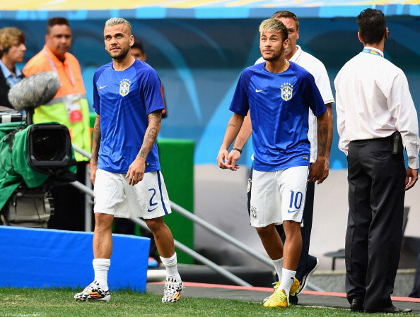 Dani Alves (left) and an injured Neymar of Brazil look on prior to the 2014 FIFA World Cup Brazil Third Place Playoff match between Brazil and the Netherlands at Estadio Nacional on July 12, 2014 in Brasilia, Brazil. (GETTY)