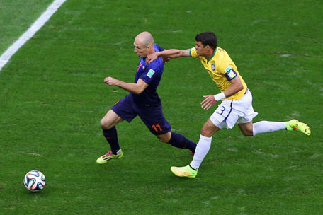 Thiago Silva of Brazil challenges Arjen Robben of the Netherlands resulting in a penalty kick for the Netherlands and yellow card for Silva during the 2014 FIFA World Cup Brazil Third Place Playoff match between Brazil and the Netherlands at Estadio Nacional on July 12, 2014 in Brasilia, Brazil. (GETTY)