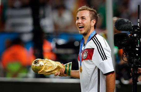 Germany's Mario Goetze holds the trophy after the World Cup final soccer match between Germany and Argentina at the Maracana Stadium in Rio de Janeiro, Brazil, Sunday, July 13, 2014. (AP)