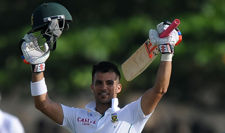 South Africa cricketer JP Duminy raises his bat and helmet in celebration after scoring a century during the second day of the opening Test match between Sri Lanka and South Africa at the Galle International Stadium. (AFP)