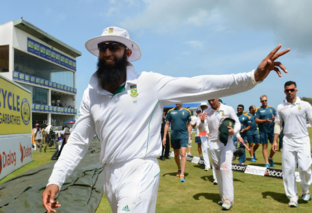 South African cricket captain Hashim Amla gestures as he leaves the field after victory in the opening Test between Sri Lanka and South Africa at the Galle International Cricket Stadium in Galle on July 20, 2014. (AFP)