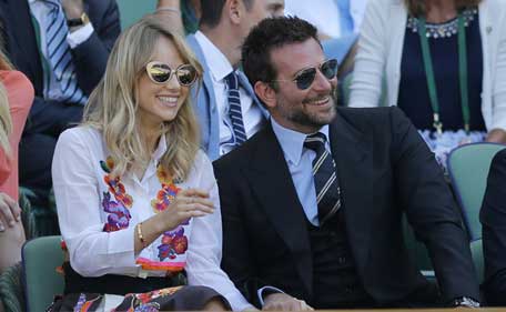 'Silver Lining Playbook' actor Bradley Cooper with his girlfriend and British model Suki Waterhouse watching a Wimbledon match. (REUTERS)