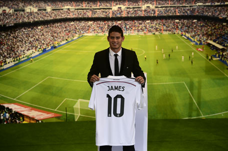 Colombian striker James Rodriguez poses during his presentation at the Santiago Bernabeu stadium following his signing with Spanish club Real Madrid in Madrid on July 22, 2014. (AFP)