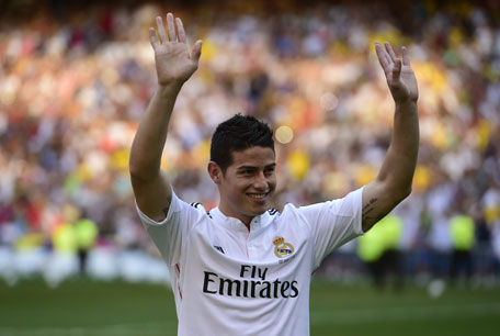 Colombian striker James Rodriguez poses during his presentation at the Santiago Bernabeu stadium following his signing with Spanish club Real Madrid in Madrid on July 22, 2014. (AFP)