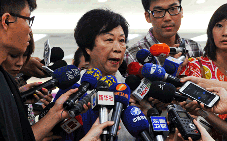 The Director of Taiwan's Civil Aeronautics Administration (CAA) Sheng Ching (2L) speaks to media at the Sungshan airport in Taipei on July 23, 2014.   More than 40 people were killed in a plane crash in Taiwan, officials said, with local television reporting the flight had smashed into two houses after an aborted landing. Authorities said Taiwanese airline TransAsia Airways flight GE222, with 58 on board, crashed near Magong airport on the outlying Penghu island after having requested a second attempt to land. (AFP)