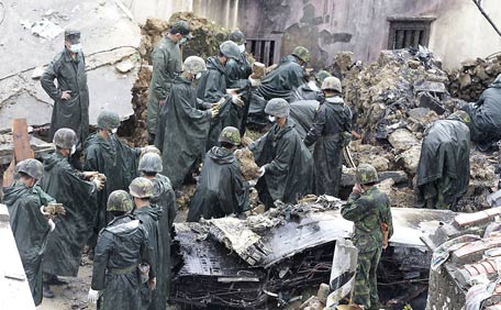 Soldiers clean up wreckage of a TransAsia Airways turboprop plane that crashed, on Taiwan's offshore island Penghu. (REUTERS)