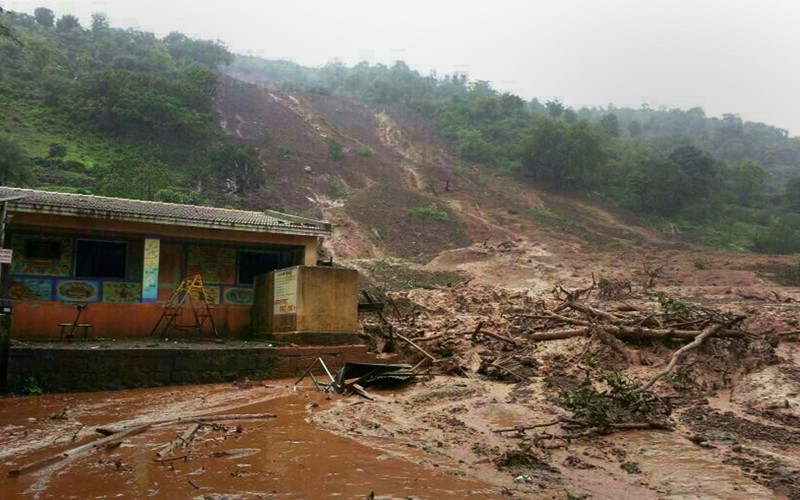 A mudslide surrounds a building in Malin village in Pune district the western Indian state of Maharashtra on July 30, 2014. (AFP)
