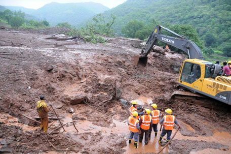 Excavators digging through mud and debris at the scene of a landslide in Malin village in Pune district, India's western state of Maharashtra, on July 30, 2014. (AFP/ MAHARASHTRA GOVERNMENT)