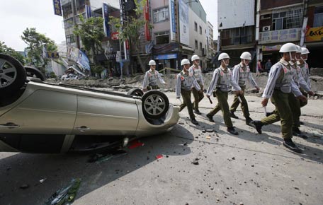 Soldiers walk through a street destroyed by a massive gas explosion in Kaohsiung, Taiwan. (AP)