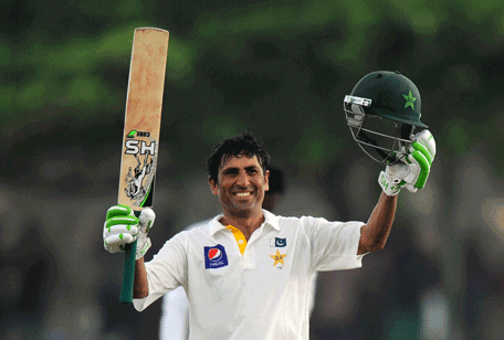 Pakistan cricketer Younis Khan raises his bat and helmet in celebration after scoring a century during the first day of the opening Test match between Sri Lanka and Pakistan at the Galle International cricket Stadium in Galle on August 6, 2014. (AFP)