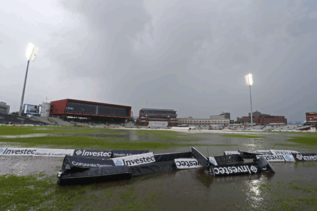 This picture shows a general view of the ground after rain stopped play during the second day of the fourth cricket Test match between England and India at Old Trafford in Manchester on August 8, 2014.     AFP