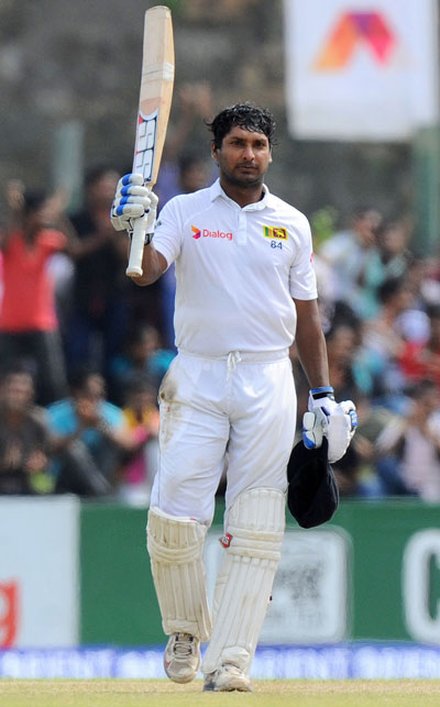 Sri Lanka's Kumar Sangakkara acknowledges the cheers after completing his 37th century on day three of the 1st Test against Pakistan at Galle International Cricket Stadium on August 8, 2014. (AFP)
