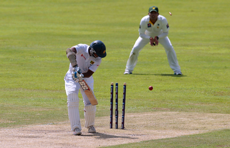 Bails fly off the wicket of Sri Lankan batsman Kumar Sangakkara during the first day of the second test cricket match between Sri Lanka and Pakistan in Colombo, Sri Lanka, Thursday, Aug. 14, 2014. (AP)