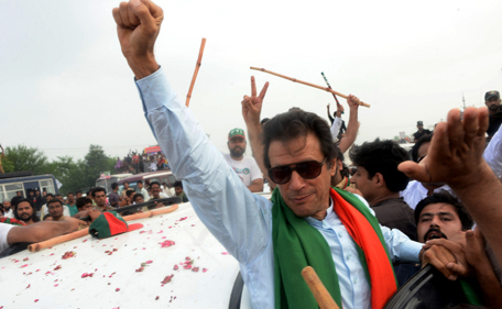 Pakistani cricketer-turned-politician Imran Khan gestures as he leads a protest march to Islamabad against the country's Pakistan Muslim League-Nawaz-led government in Wazirabad in eastern Punjab province on August 15, 2014. Clashes broke out on August 15, 2014 as protesters led in convoys by cricketer-turned-politician Imran Khan and a populist cleric advanced on the Pakistani capital to try to topple the government they say was elected by fraud. Khan and preacher Tahir-ul-Qadri say the May 2013 general election that brought Prime Minister Nawaz Sharif to power in a landslide was rigged, and are demanding he resign and hold new polls. (AFP)