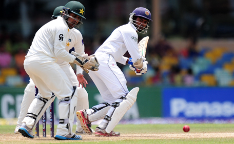 Sri Lankan batsman Upul Tharanga (R) plays a shot as Pakistan wicketkeeper Sarfraz Ahmed (L) reacts during the third day of the second Test match between Sri Lanka and Pakistan at The Sinhalese Sports Club (SSC) Ground in Colombo on August 16, 2014. AFP