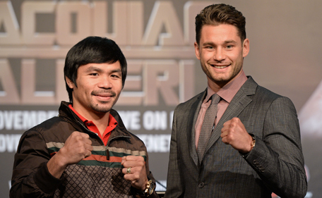 Philippine boxing icon Manny Pacquiao (L) and Chris Algieri (R) of the US pose for photographs during a pre-fight press conference in Macau on August 25, 2014. Pacquiao will take on Algieri in a World Boxing Organization (WBO) welterweight title fight in Macau on November 23. (AFP)
