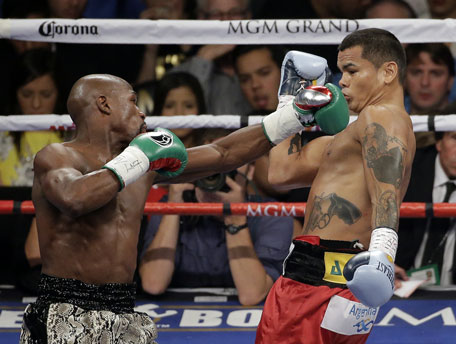 Floyd Mayweather punches Marcos Maidana, right, during their WBA welterweight and WBC super  welterweight title fight, Saturday, Sept. 13, 2014, in Las Vegas. (AP)