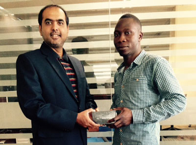 Winner and Abu Dhabi resident Hiza Olaniyi Bamidele receives his brand new iPhone 5 from emirates247.com Deputy Managing Editor, Roopesh Raj.