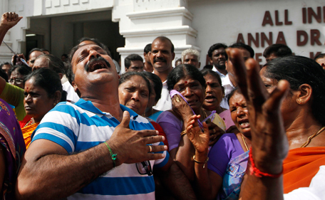 All India Anna Dravida Munnetra Kazhagam (AIADMK) party workers cry after a verdict was handed down to party leader and Tamil Nadu state Chief Minister Jayaram Jayalalitha as a court in Bangalore found her guilty of possessing wealth disproportionate to her known sources of income, in Chennai, India, Saturday, Sept. 27, 2014. The charismatic former actress who later joined politics and became the top elected official in the southern Indian state was sentenced to four years in jail after the court found her guilty of corruption in the case filed 18 years ago. (AP)