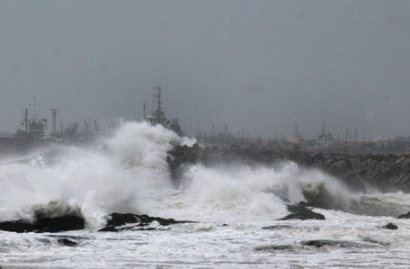 Large waves buffet the coastline ahead of Cyclone Hudhud making expected landfall in Visakhapatnam.  India placed its navy on high alert and evacuated around 350,000 people from eastern coastal areas as it prepared for a severe cyclone to hit on October 12, 2014.  (AFP)