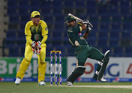 Asad Shafiq of Pakistan bats as Brad Haddin of Australia looks on during the third match of the one day international series between Australia and Pakistan at Sheikh Zayed Stadium on October 12, 2014 in Abu Dhabi, United Arab Emirates. (GETTY)