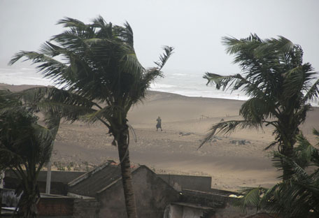 A man walks as strong winds blow along a beach in Gopalpur in Ganjam district in the eastern Indian state of Odisha October 12, 2014. Cyclone Hudhud blasted India's eastern seaboard on Sunday with gusts of up to 195 kilometers an hour (over 120 mph), uprooting trees, damaging buildings and killing at least two men despite a major evacuation effort. (REUTERS)