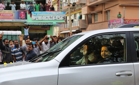 Former chief minister of Tamil Nadu state Jayaram Jayalalitha waves to supporters as she travels in car after being released from prison in Bangalore, India, Saturday, Oct. 18, 2014. India's top court Friday granted temporary bail to a charismatic southern Indian politician who was sentenced to four years in prison for corruption last month. (AP)