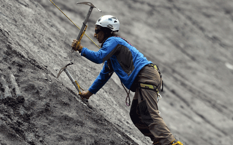 In this photograph taken on August 4, 2014, a Pakistani student from the Shimshal Mountaineering School uses ice axes to climb a slope on a glacier near the Shimshal village in the northern Hunza valley. Breaking taboos and pursuing jobs traditionally done by men, the first batch of women to train as high altitude guides at northern Pakistan's remote Shimshal Mountaineering School are preparing to put four years of hard study to the test.  AFP
