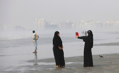 Girls clad in burqas take picture with a tablet while visiting Karachi's Clifton beach October 28, 2014. According to local media, Pakistan authorities closed coastal belt due to the tropical cyclone Nilofar which has gained further strength as it continue to move inwards. (REUTERS)