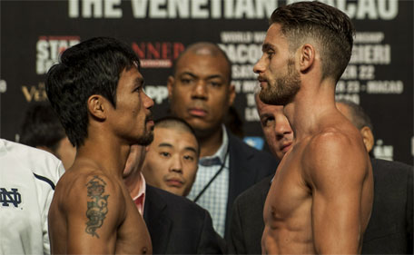 Manny Pacquiao (left) and Chris Algieri face each other during the official weigh-in ahead of their World Welterweight Championship bout at the Cotai Arena in Macau on November 22, 2014. (AFP)
