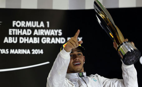 Mercedes Formula One driver Lewis Hamilton of Britain celebrates on the podium after winning the Abu Dhabi F1 Grand Prix at the Yas Marina circuit in Abu Dhabi November 23, 2014.  (Reuters)
