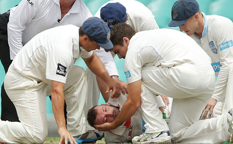 Phillip Hughes of South Australia is helped by New South Wales players after falling to the ground after being struck in the head by a delivery during day one of the Sheffield Shield match between New South Wales and South Australia at Sydney Cricket Ground on November 25, 2014 in Sydney, Australia. (Getty)