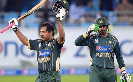 Pakistani batsman Sarfraz Ahmed (left) celebrates after scoring fifty during the first International T20 cricket match at Dubai International Stadium in Dubai. (AFP)