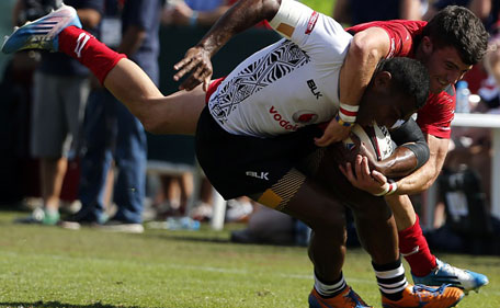 Apisalome Waqatabu (front) of Fiji is tackled by Luke Morgan of Wales during their quarter-final rugby match in the Dubai leg of IRB's Sevens World Series on December 6, 2014. (AFP)