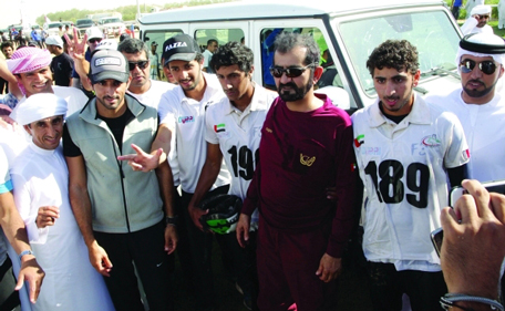 Sheikh Mohammed attends the National Day Cup 120km endurance race. Also in attendance is Sheikh Hamdan bin Mohammed bin Rashid Al Maktoum. (Al Bayan)