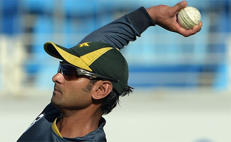 Pakistani all-round cricketer Mohammad Hafeez throws a ball during a net practice session at Dubai International Stadium in Dubai on December 7, 2014. (AFP)