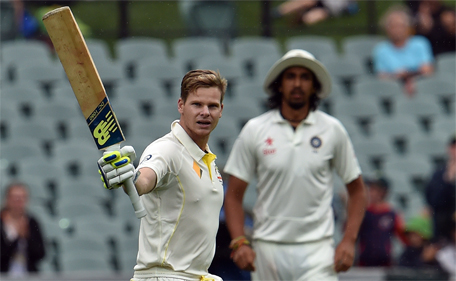 Australia's batsman Steve Smith (left) celebrates as he reaches his century during the second day of the first Test between Australia and India at the Adelaide Oval on December 10, 2014. (AFP)