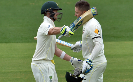 Australia's captain Michael Clarke (right) celebrates his century with teammate Steve Smith on the second day of the first Test between Australia and India at the Adelaide Oval on December 10, 2014. (AFP)