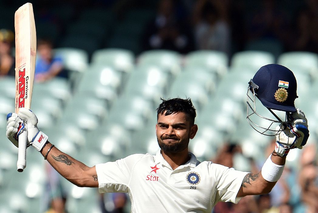 India's batsman Virat Kohli celebrates his century during the third day of the first Test cricket match between Australia and India at the Adelaide Oval. (AFP)