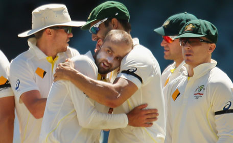 Nathan Lyon of Australia is congratulated by Mitchell Johnson after taking a catch from his own bowling to dismiss Rohit Sharma of India during day four of the first Test between Australia and India at the Adelaide Oval on December 12, 2014 in Adelaide, Australia. (Getty)