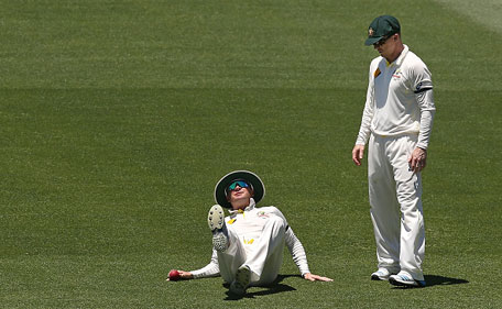 Michael Clarke of Australia collapses next to Chris Rogers after injuring himself when fielding the ball during day five of the first Test between Australia and India at Adelaide Oval on December 13, 2014 in Adelaide, Australia. (Getty)